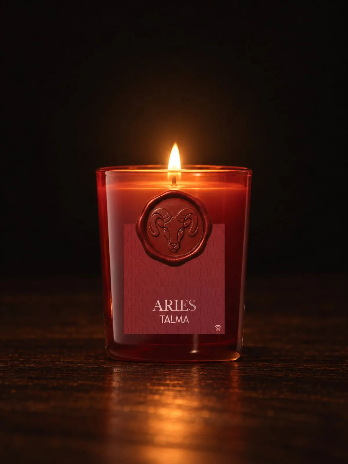 The Aries candle lit in the night, red glass